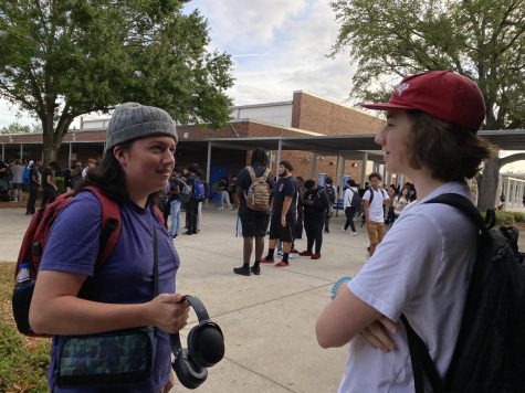 Senior Ande Christenson (left) and junior Ryan Casey (right) show off their ability to wear hats with the new additions to the dress code policy.
