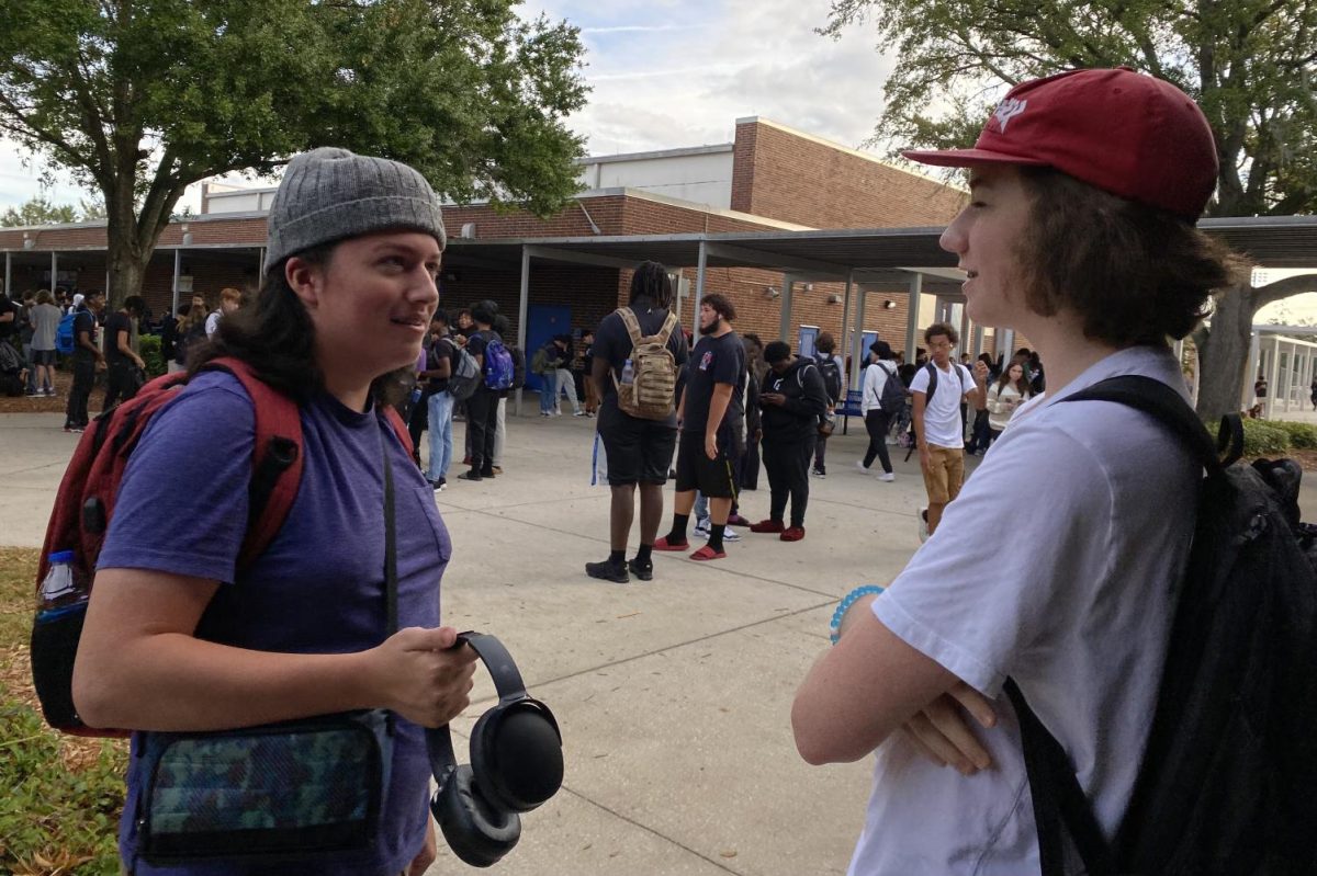 Senior Ande Christenson (left) and junior Ryan Casey (right) show off their ability to wear hats with the new additions to the dress code policy.