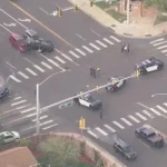 Police response at a crashed intersection in Aurora with emergency vehicles nearby