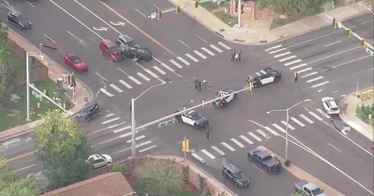 Police response at a crashed intersection in Aurora with emergency vehicles nearby